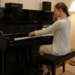a girl practicing piano